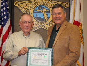 Sheriff giving plaque to Zimmie Petty