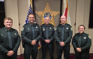 Ceremonial swearing in photo of Matthew Laux, Dallas Sapp, Sheriff Wallace Kitchings, Troy Schlicht, and Cassandra Hall